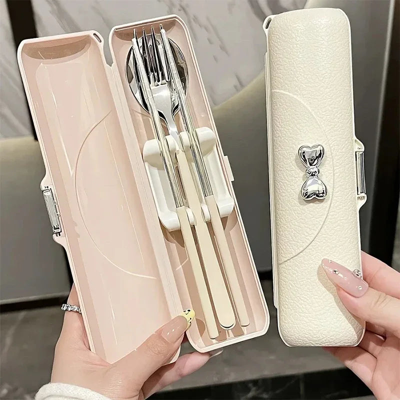 Someone holding up a set of pink kawaii utensils