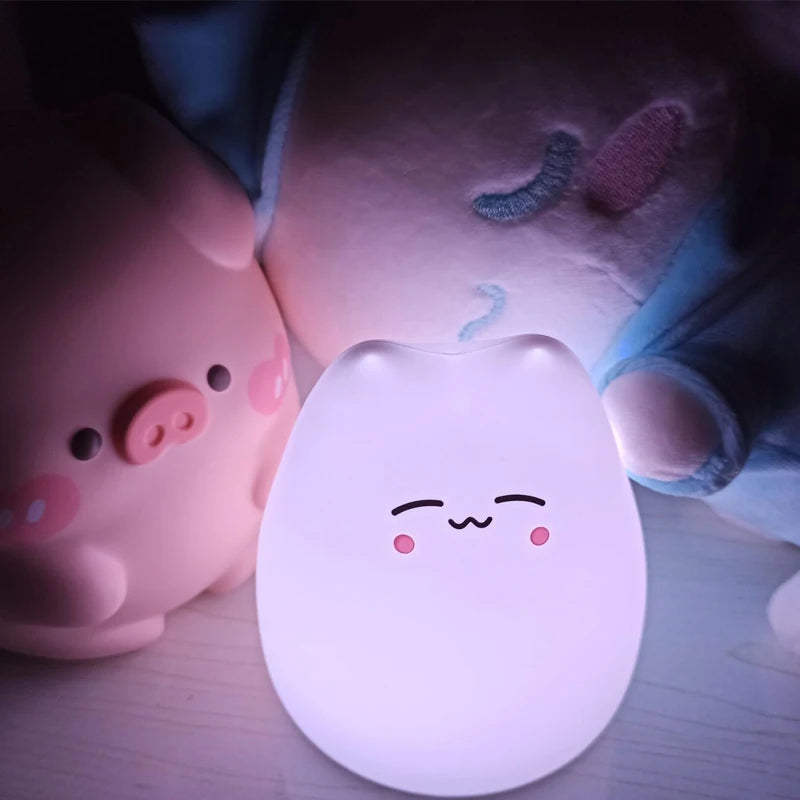 Cute kawaii animal-shaped night lights on a wooden surface