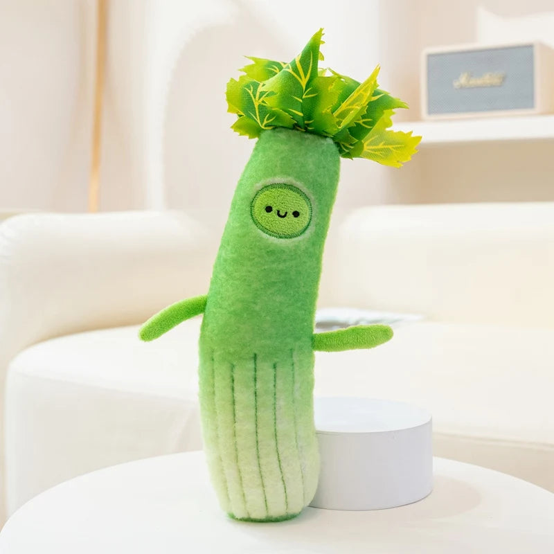 Green kawaii plush toy resembling a vegetable on a white surface with a blurred background