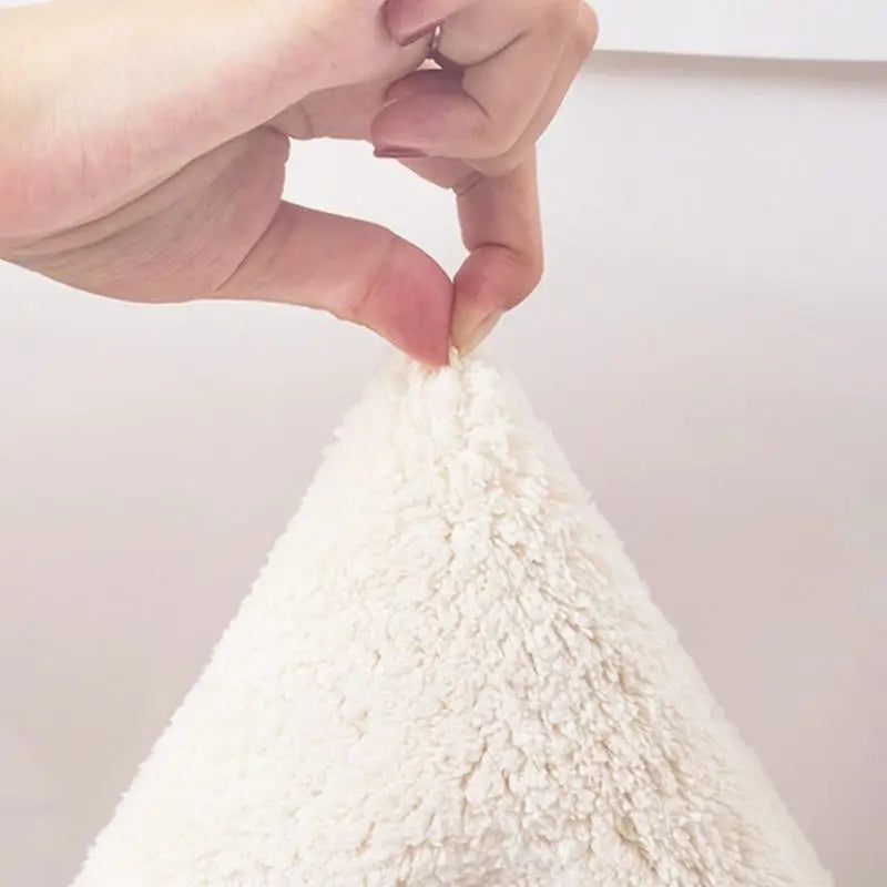 Close-up of a hand holding a small white kawaii rug