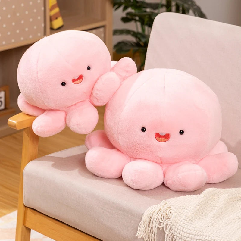 Two pink kawaii plush octopus toys on a chair with a neutral background