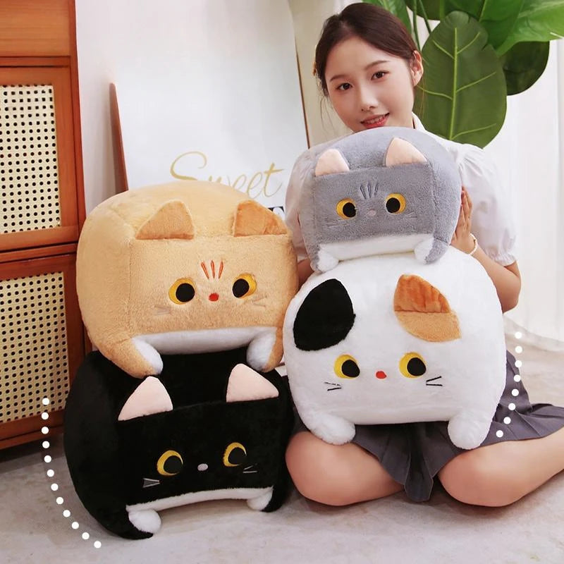 Woman sitting with three cat-shaped kawaii plush toys in a home setting