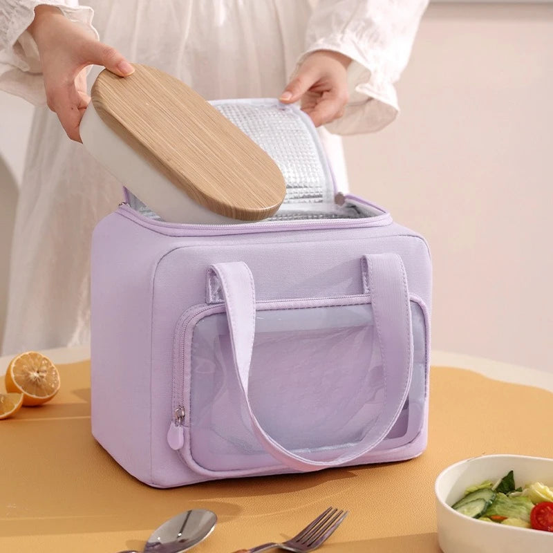 Purple kawaii lunch bag with a wooden lid on a table with a salad and lemon.