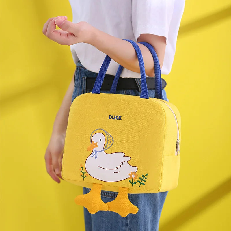 Yellow bag with duck design held by a person against a yellow background