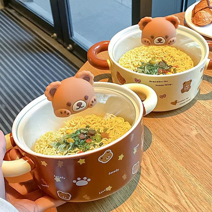 Two kawaii ramen bowls with bear-shaped lids on a wooden table.