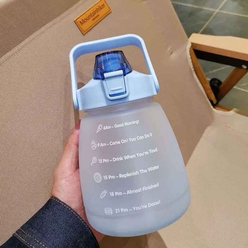 Hand holding a kawaii water bottle with text on a beige chair.