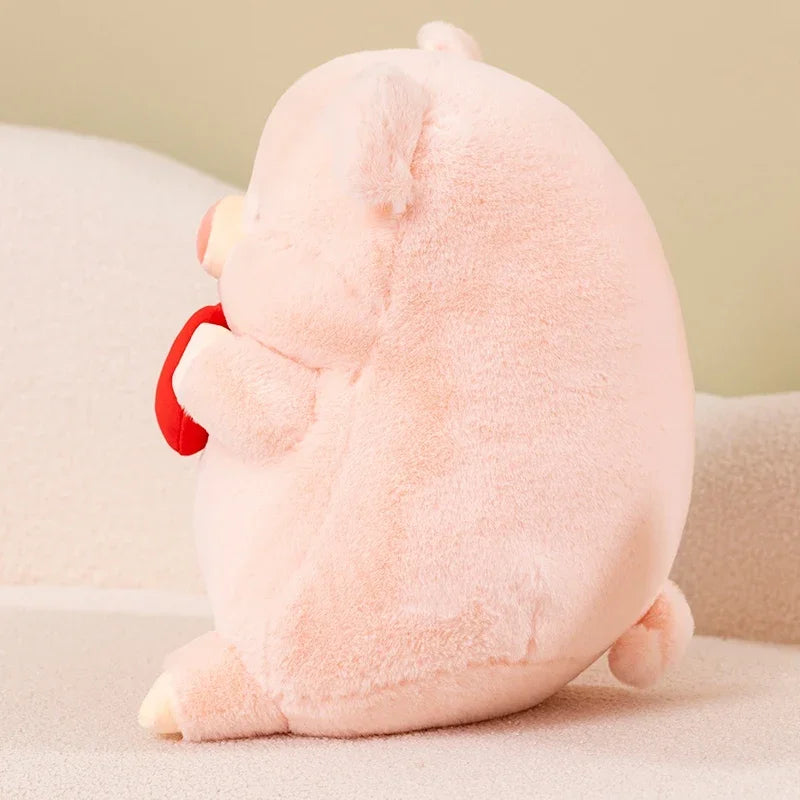 Kawaii plush pig toy with a red nose on a light background