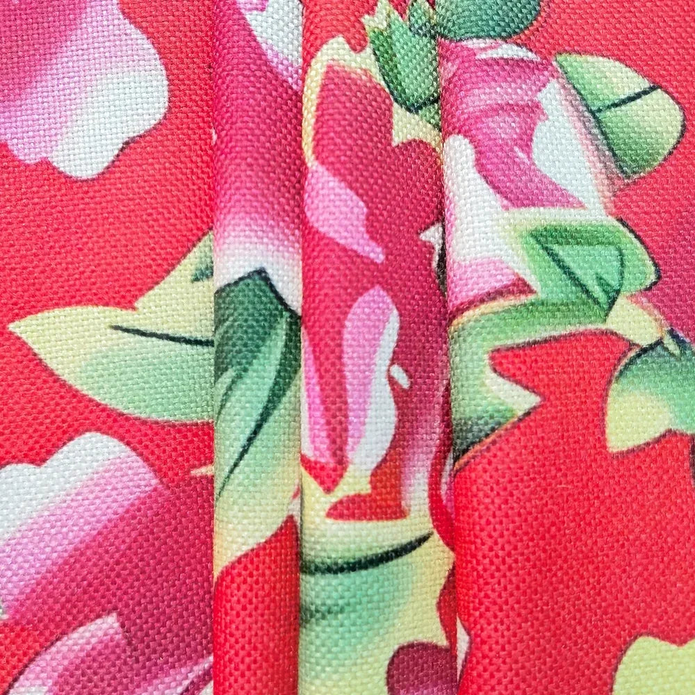Close-up of kawaii apron with pink floral pattern on a red background