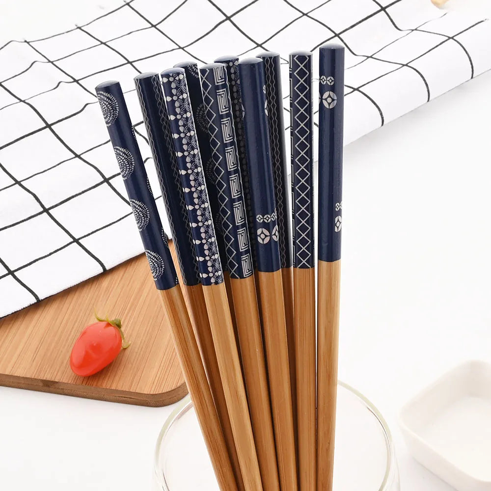 Set of wooden kawaii chopsticks with blue handles on a white background