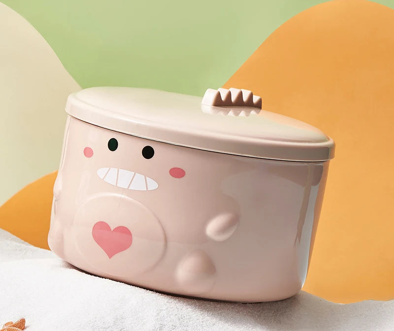 A pink monster shaped kawaii ramen bowl on a table