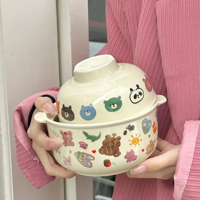 Person holding a ceramic kawaii bowl with cartoon animal designs