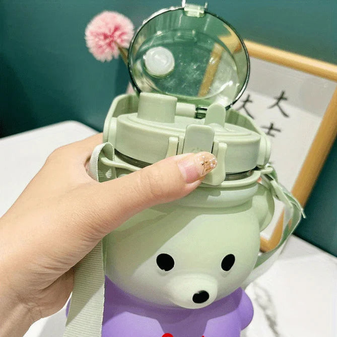 Green bear-shaped kawaii water bottle with a mirror on top, held by a hand.