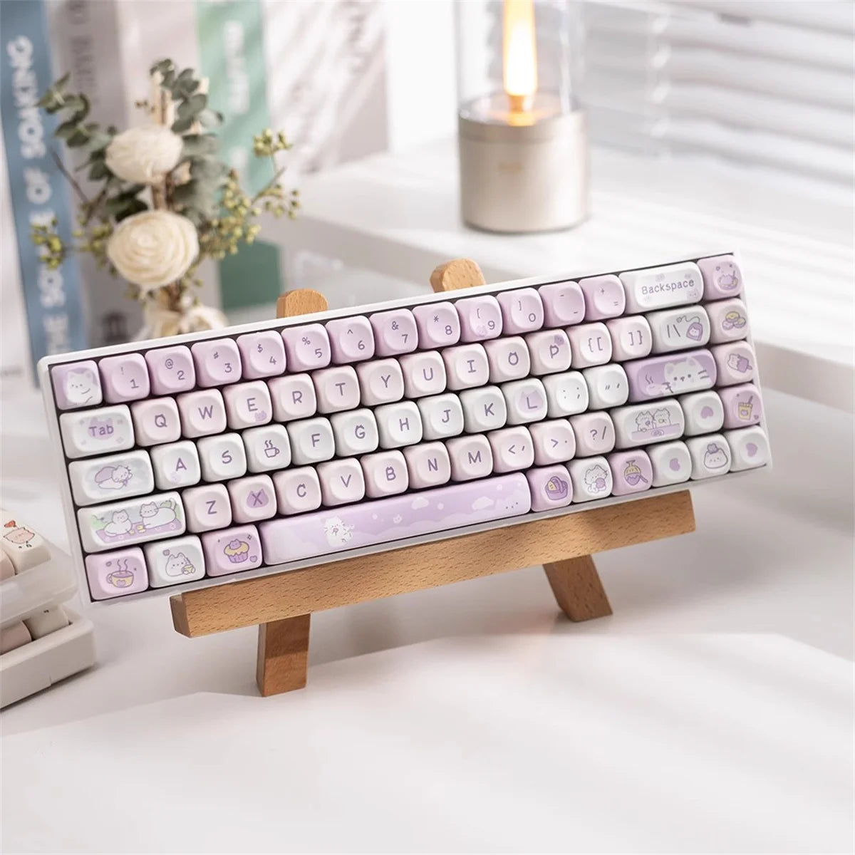 Keyboard with decorative Kawaii keys on a wooden stand against a blurred indoor background