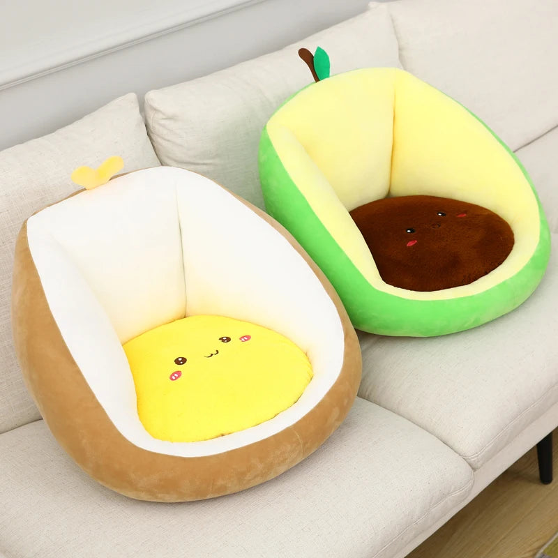 Two avocado-shaped kawaii plush toys on a light-colored couch.