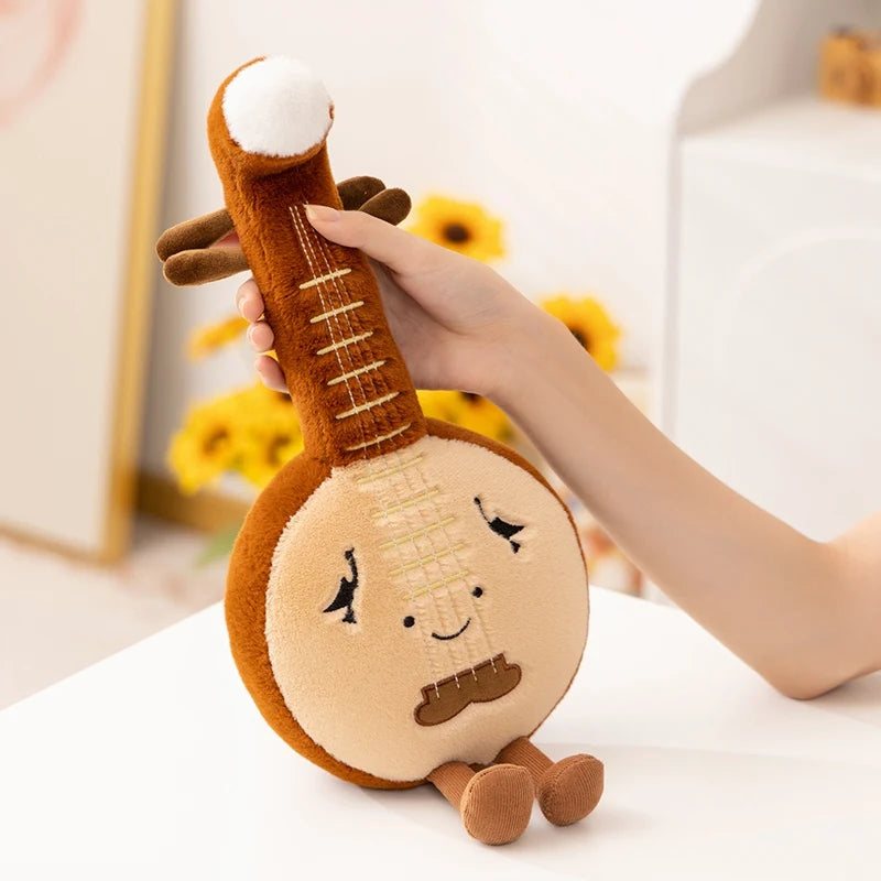 Kawaii plush toy resembling a musical instrument held by a hand with a blurred background