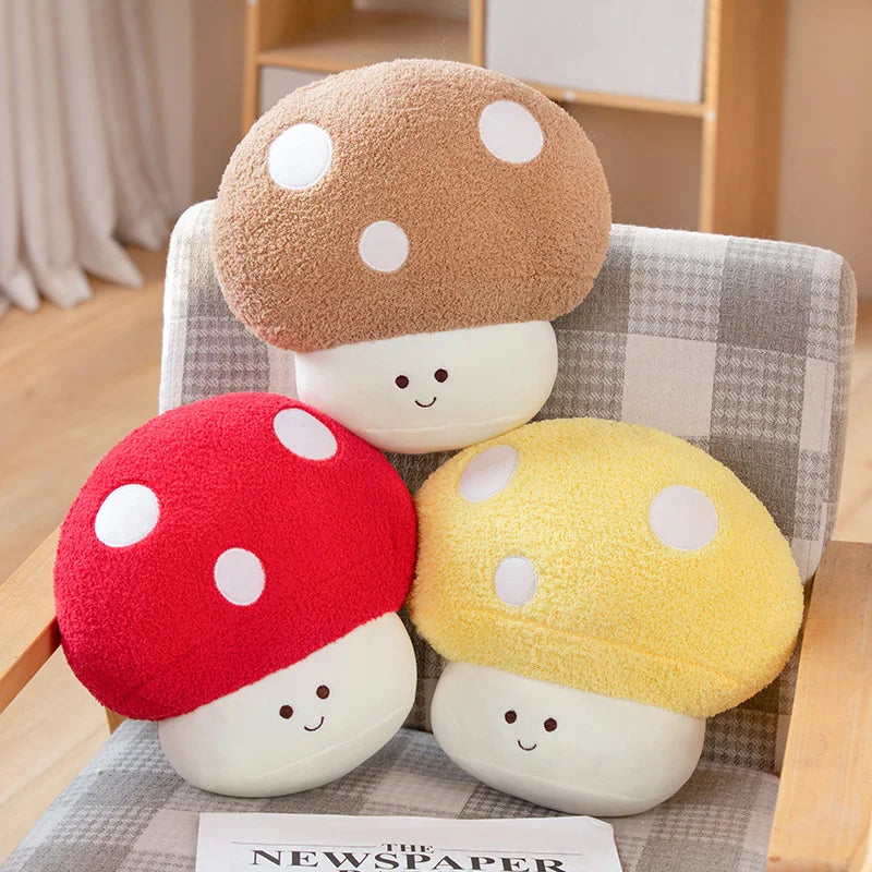 Three colorful mushroom-shaped kawaii cushions on a chair with a newspaper underneath.