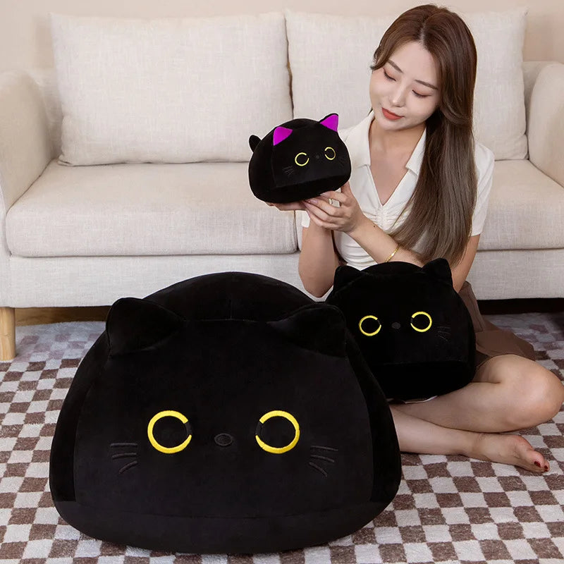 Woman holding a black cat-shaped kawaii plush toy in a living room setting