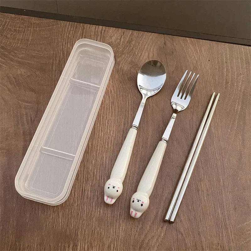 A set of white, rabbit shaped kawaii utensils on the table
