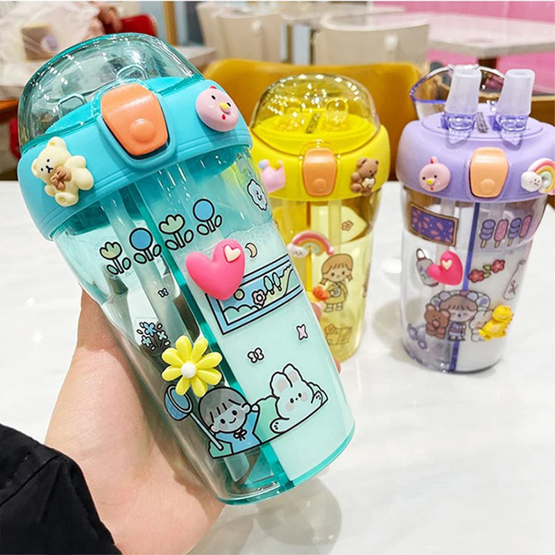 Colorful children's kawaii cups with cartoon designs on a table.
