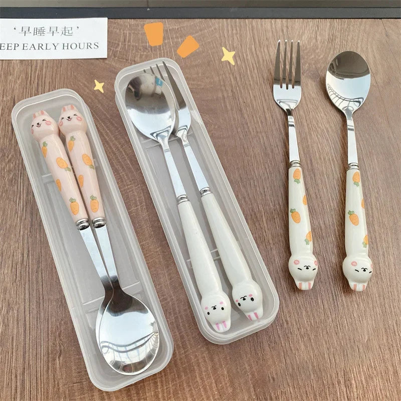 Set of children's kawaii utensils with cartoon animal handles on a wooden surface.