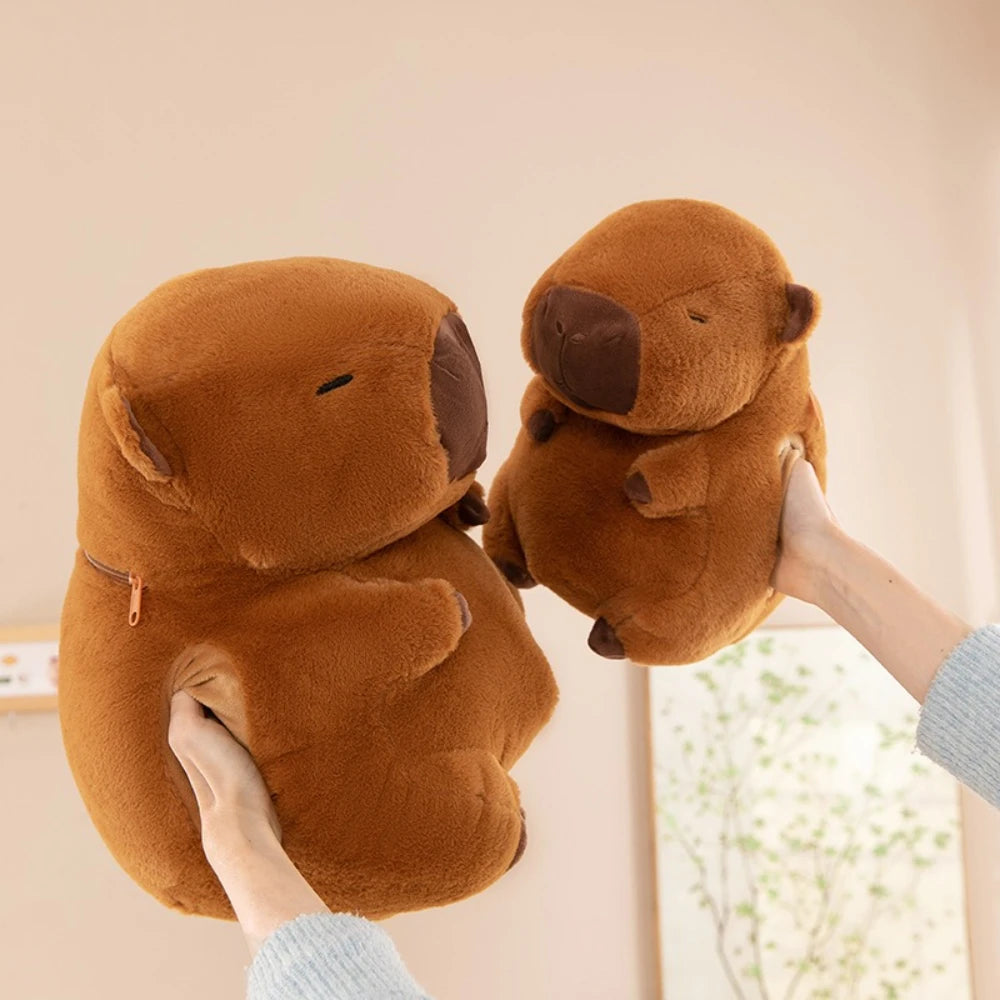 Two brown kawaii plush bear slippers held by a person against a neutral background