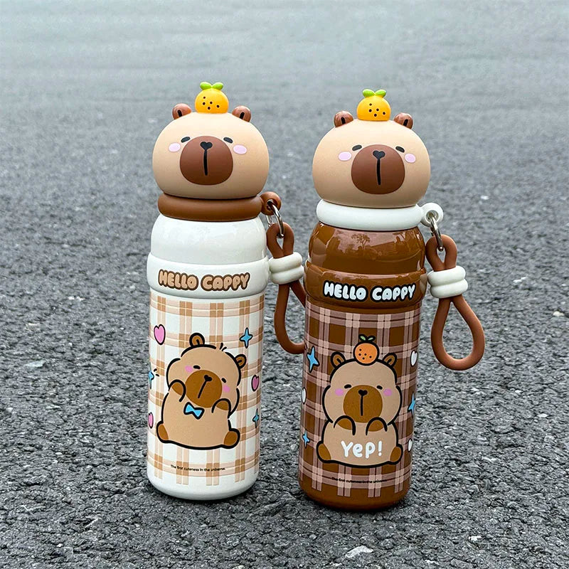 Two cartoon bear-themed kawaii water bottles on a gray surface