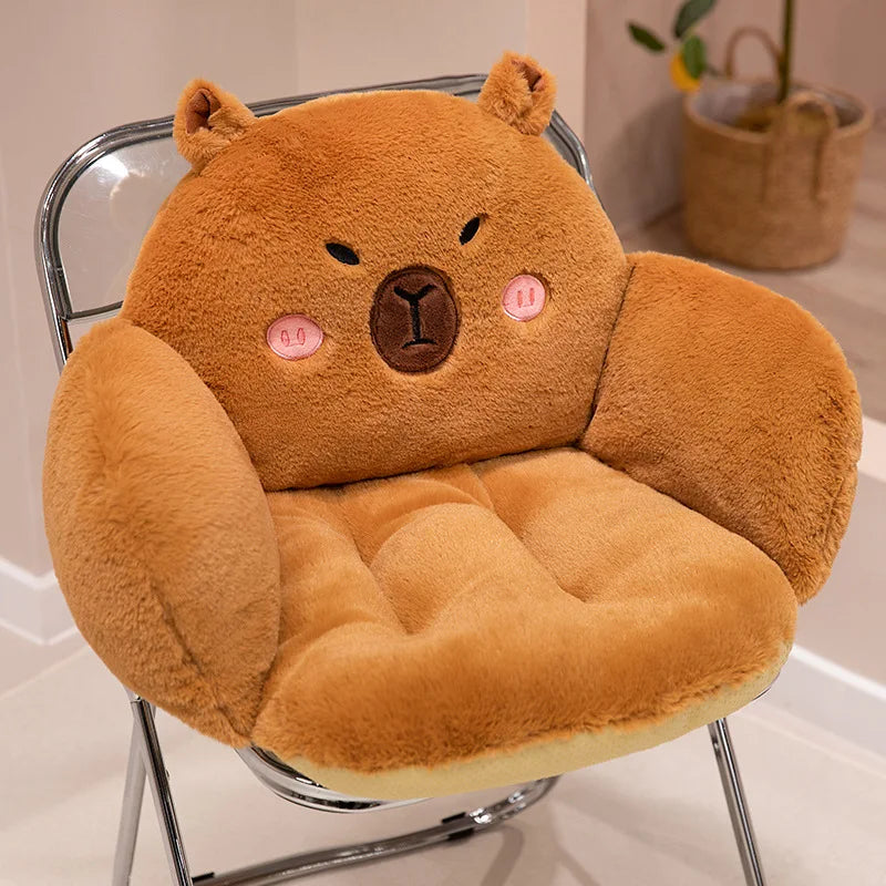 Brown bear-shaped kawaii cushion on a chair with a neutral background