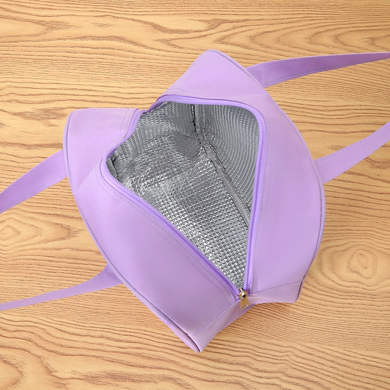 Purple kawaii lunch bag on a wooden surface