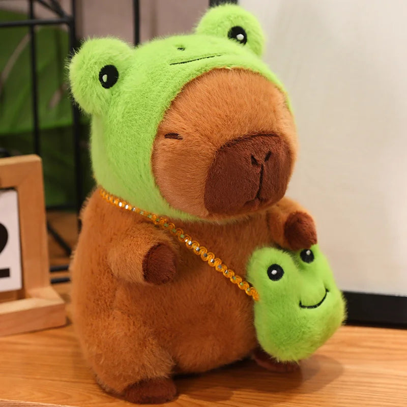 Kawaii plush toy bear with a green frog on its back on a wooden surface.
