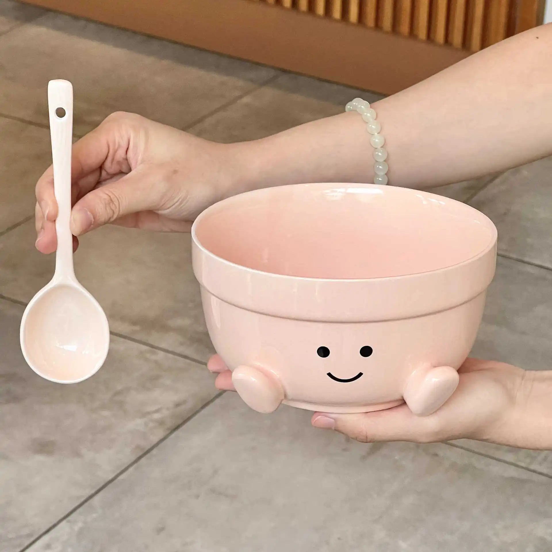 A pink kawaii bowl being held by a person