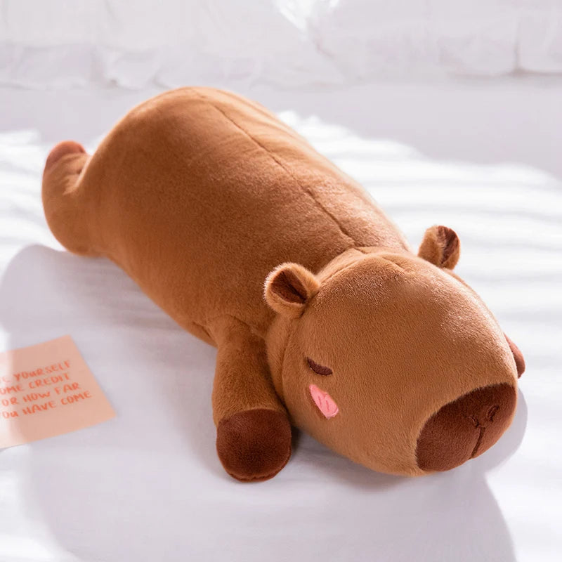 Brown hippo-shaped kawaii pillow on a white surface