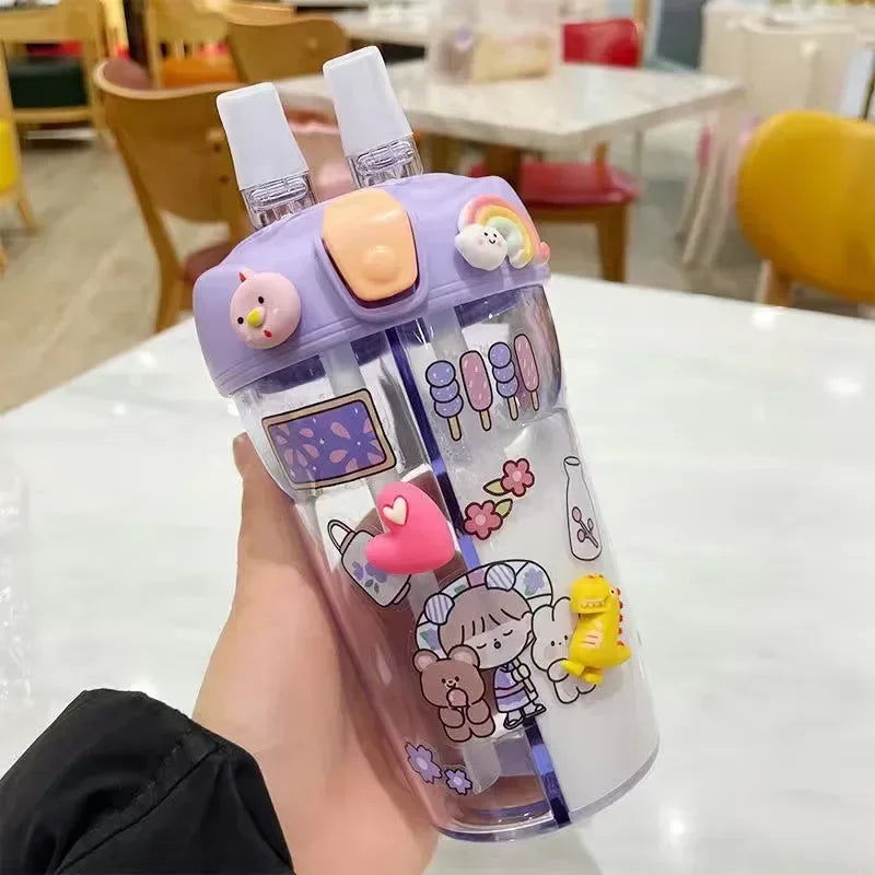 Colorful kawaii water bottle with cartoon designs held by a person in an indoor setting.