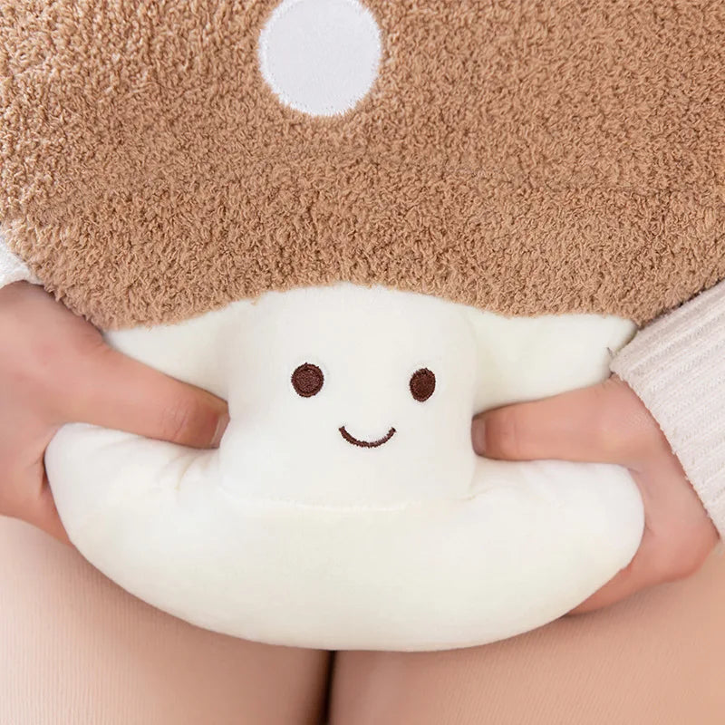 Cute kawaii plush mushroom toy held by a person with a soft brown cap and white stem.