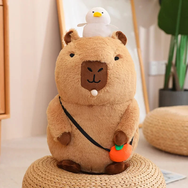 Plush kawaii toy resembling a beaver with a duck on its head, sitting on a woven stool.