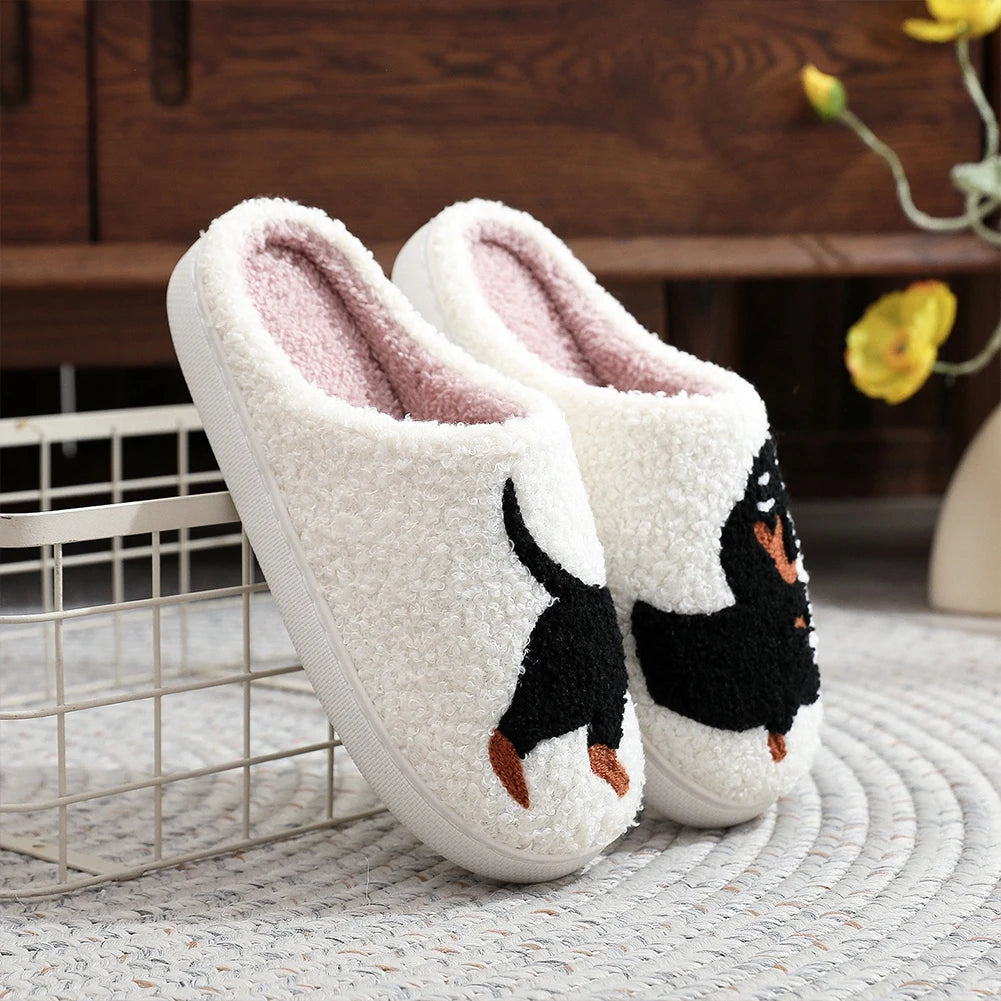 Pair of white kawaii slippers with penguin design on a textured surface.