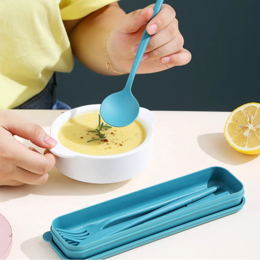 Child using a blue kawaii utensils to eat soup from a white bowl, with additional blue spoons in a holder.