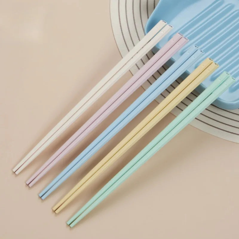 Set of colorful kawaii chopsticks on a beige background