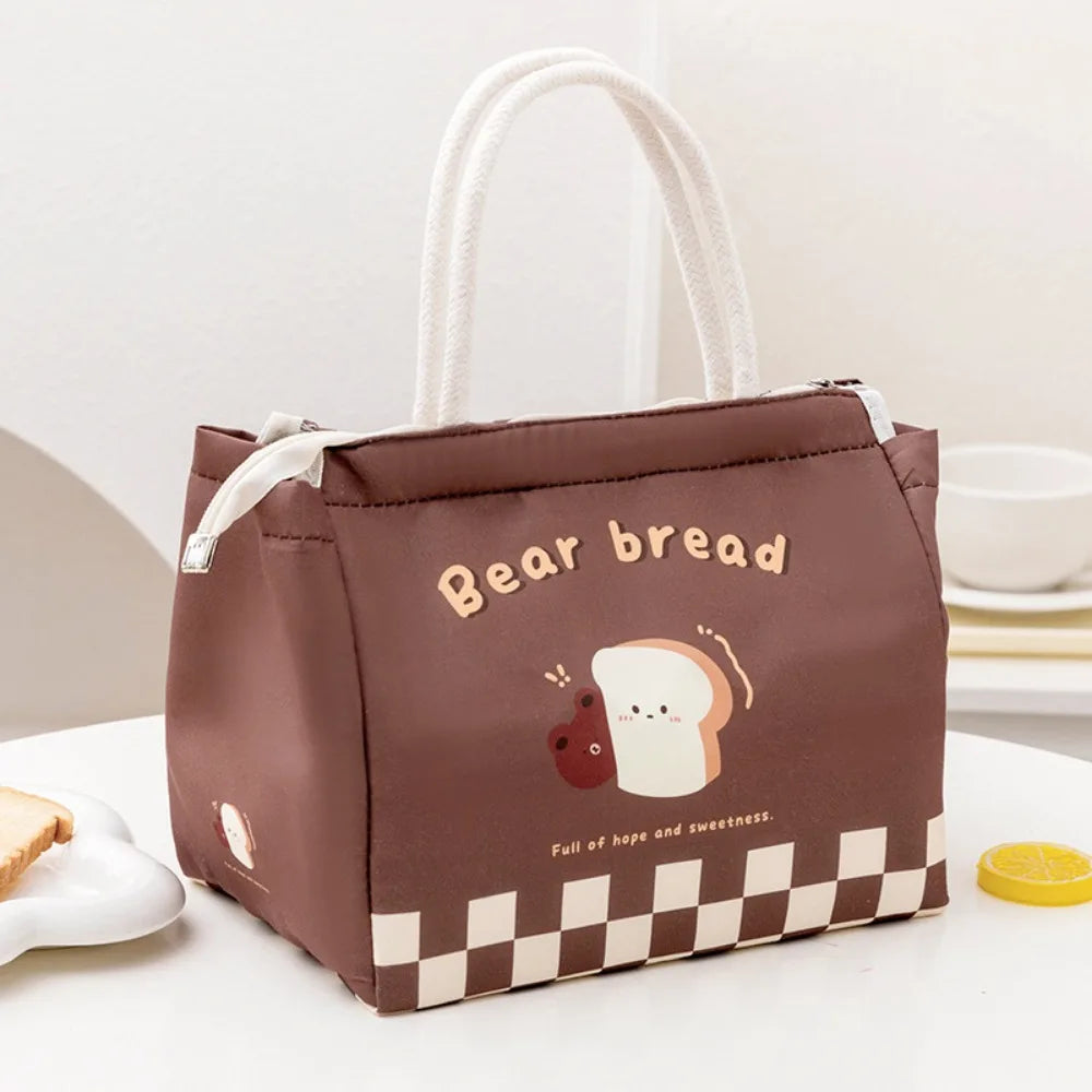 Brown kawaii lunch bag with 'Bear bread' design on a white surface