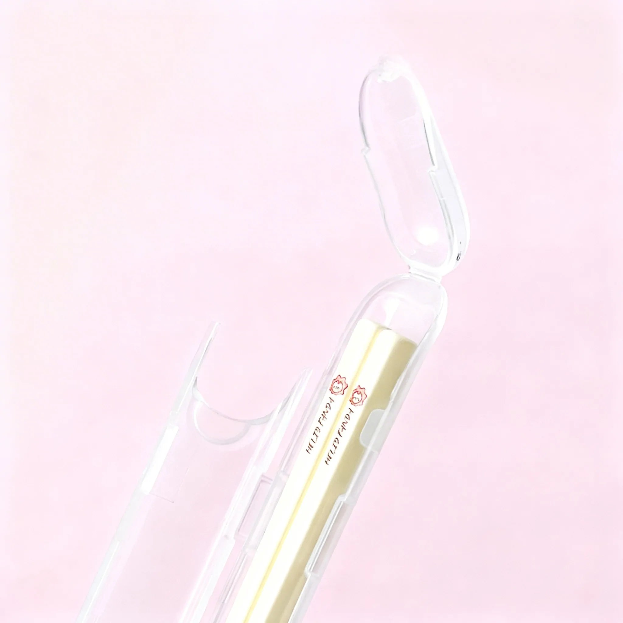 Kawaii chopsticks with gold accents on a pink background