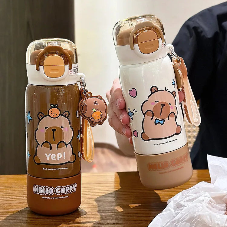 Two cartoon-themed kawaii water bottles with bear designs on a wooden surface.