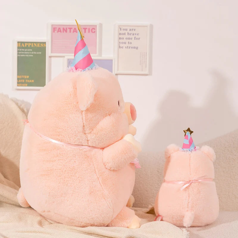 Two pink kawaii plush toys with party hats on a light-colored surface.
