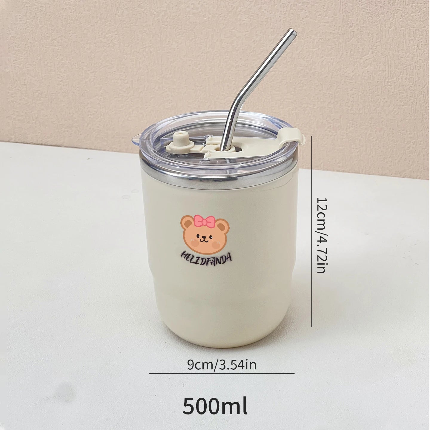 White kawaii tumbler with bear design and straw on a beige background
