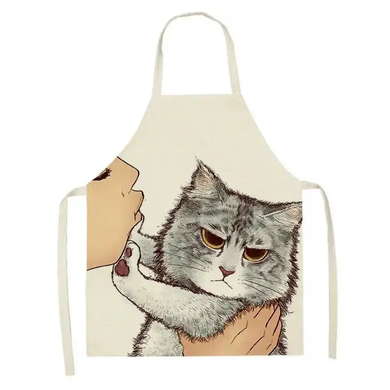 Kawaii apron with a design of a cat being held by a person's face on a white background