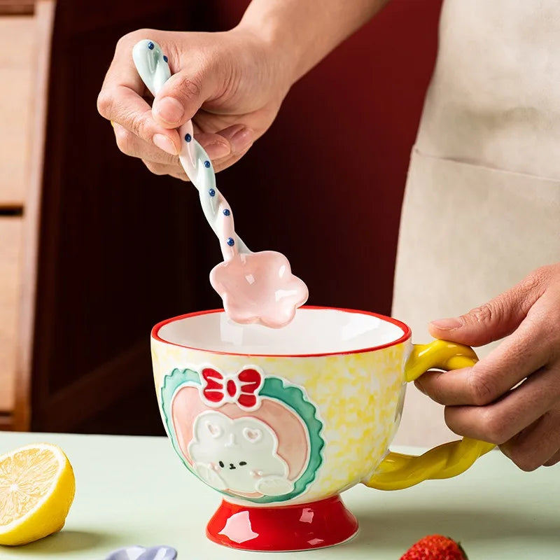 A person holding a white and pink kawaii spoon