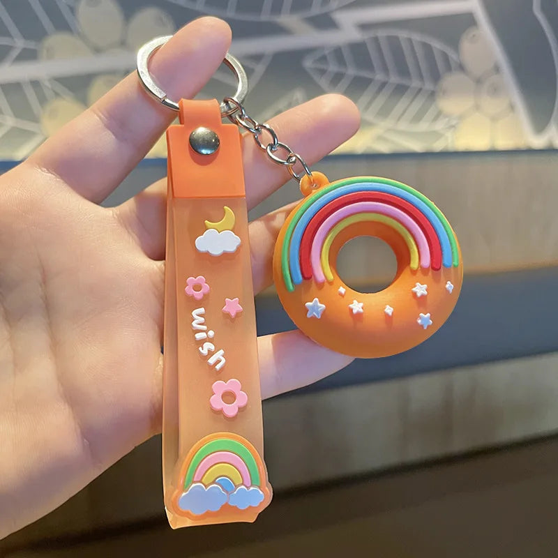 Colorful kawaii keychain with rainbow design held by a hand