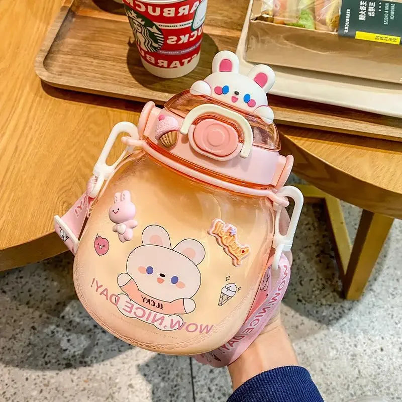 Children's kawaii water bottle with cartoon design held by a person, Starbucks cup in the background