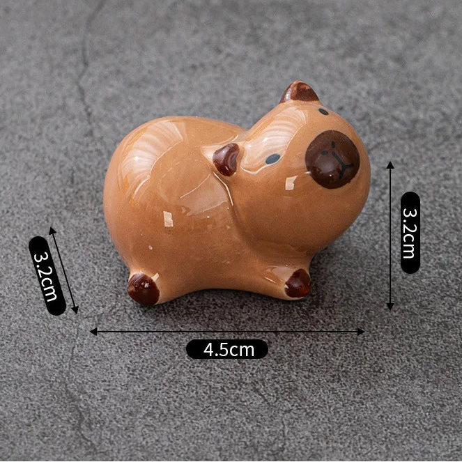 Brown ceramic kawaii animal-shaped item with measurements on a gray background