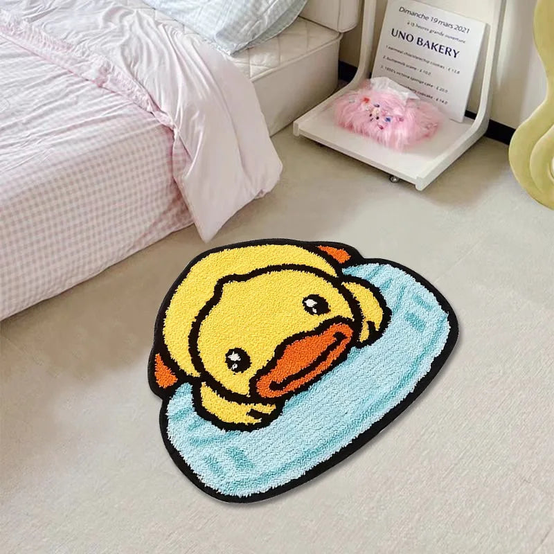 Rubber duck-shaped kawaii rug on a light-colored floor with a bed and chair in the background.