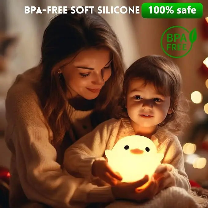 Woman and child holding a soft silicone kawaii night light with BPA-free label.