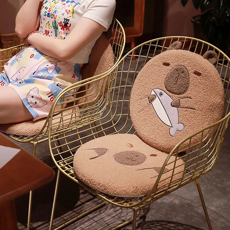 Children's cartoon-patterned shorts and shoes on a chair with bear-shaped kawaii cushions.